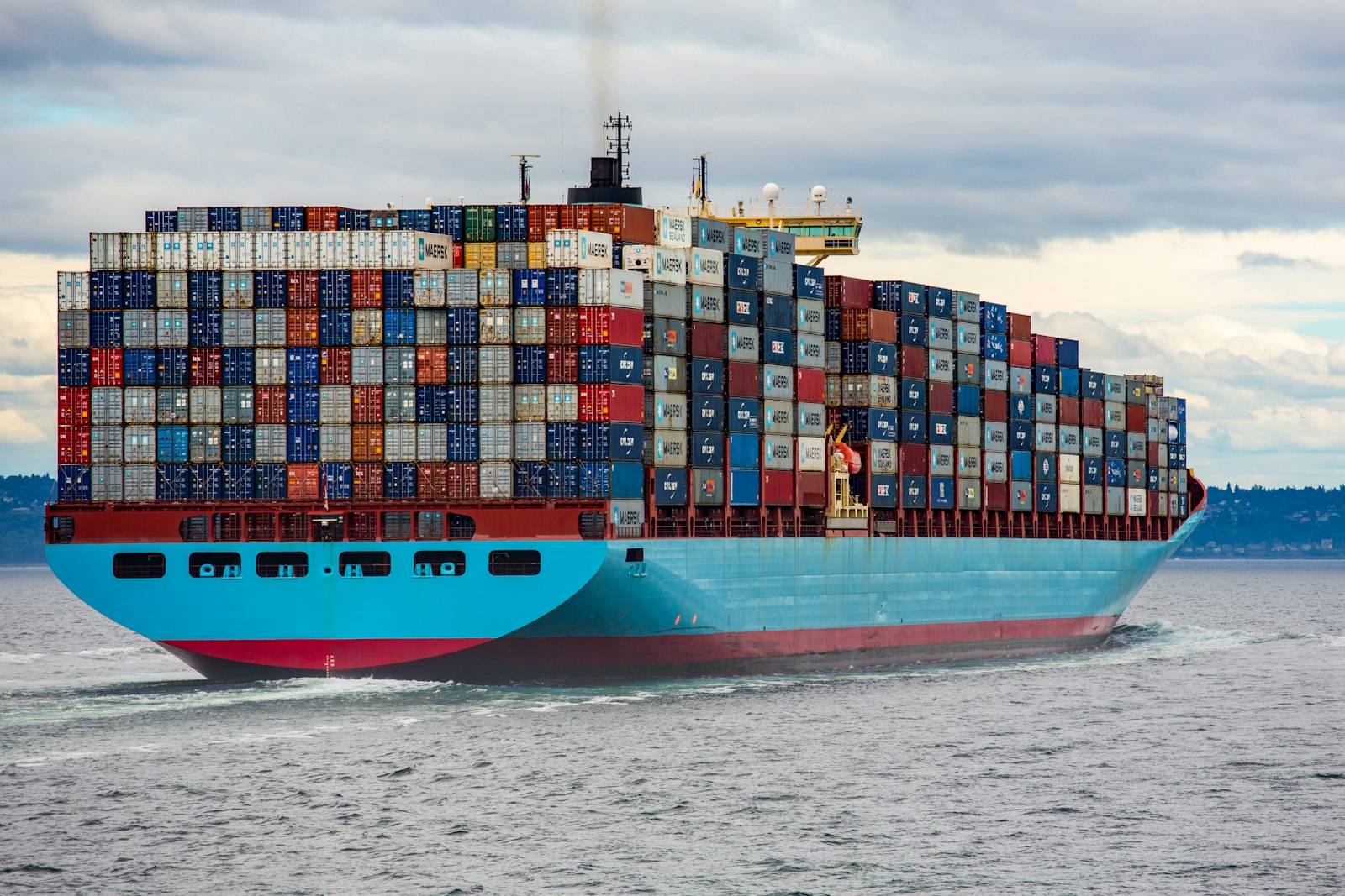 Stacked shipping containers at a cargo port, ready for international freight